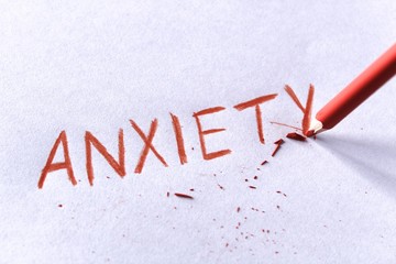 Anxiety concept. Word anxiety written on white paper