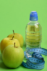 Athletics and weight loss concept. Water bottle with measure tape