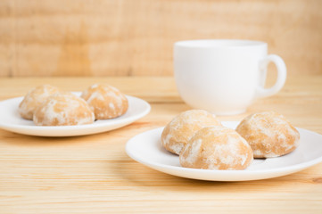 gingerbread on plates and  coffee wiht milk on a wooden background. breakfast or snack