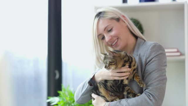 Woman working from home with pet cat