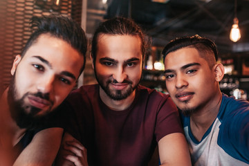 Group of arabian friends taking selfie in lounge bar. Mixed race best friends having good time together