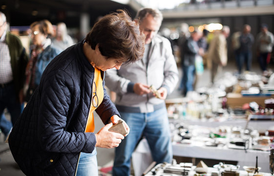 Woman  Buying Retro Handicrafts On Indoor Flea Market