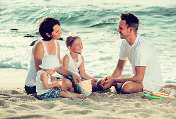Fototapeta premium happy family of four at beach.