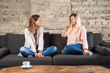 Two women on sofa having fun