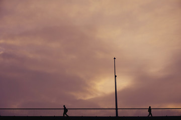 Fototapeta na wymiar Silhouette two person walking on bridge with lanterns