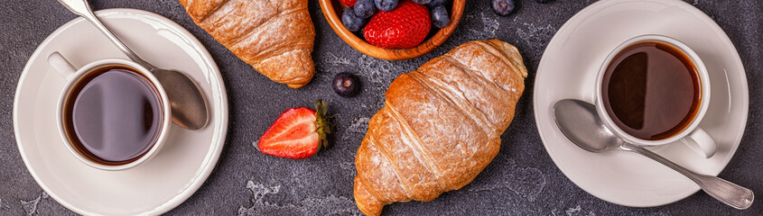 Breakfast with fresh croissants, orange juice and coffee.