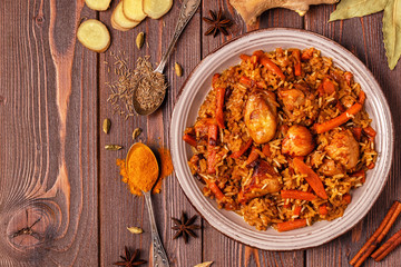 Pilaf (biryani) on a wooden background, top view, copy space.