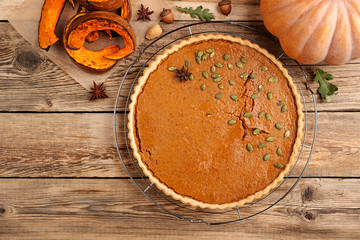Pumpkin homemade pie on wooden background. top view
