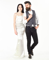 Bearded hipster with bride dressed up for wedding ceremony. Woman in wedding dress and man in vest. Wedding concept. Couple in love, bride and groom in elegant wedding clothes, white background.