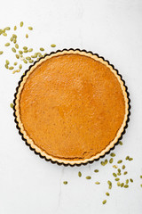 Pumpkin pie, tart. Grey stone background. Top view