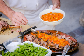 Chef preparing cuisine with peppers