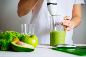 smoothie ingredients in front. woman making smoothie on background. health food concept