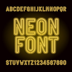 Yellow neon tube alphabet font. Neon color letters, numbers and symbols. Stock vector typeface for any typography design.