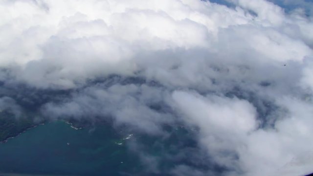 Beautiful aerial of a cloud covered coastline in Africa from an overhead airplane
