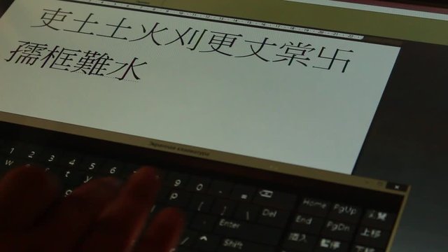 Typing Chinese calligraphy hieroglyph mandarine letters on touchscreen keyboard