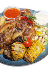 a large piece of meat with corn and potatoes