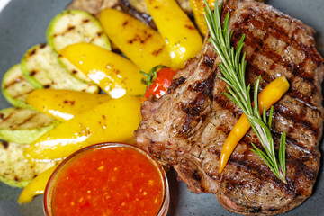 grilled meat on bone with garnish of vegetables