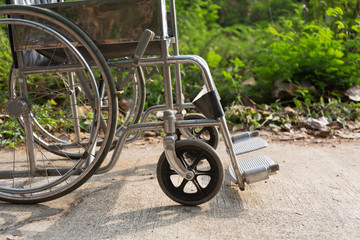 Fototapeta na wymiar Wheelchair on the concrete road, outdoor.
