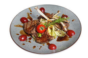 grilled meat on bone with garnish of vegetables