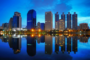 A Beautiful Benchakitti Park near the skyscraper business district,View Bangkok city with park at twilght with reflection of skyline,Thailand