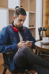 young adult fashion with mobile phone in the cafeteria