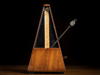 Detail of an old mechanic musical metronome