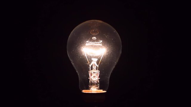 Electric light bulb being dimmed from full brightness to off