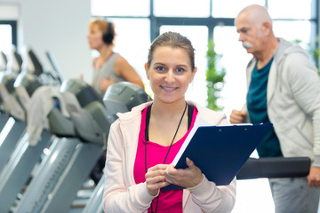 beautiful female personal trainer at gym