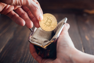 Fototapeta premium Man hand with coin. Bitcoin symbol