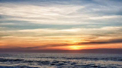 Naklejka na ściany i meble Beautiful sunset on the ocean