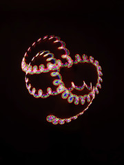 Neon tracks of the spiral are blurred in motion. tracks of colored lights.