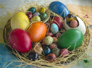 Theme Easter. Close-up of a multicolored egg of quail, hen and duck on straw.