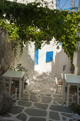 Outdoor part of taverna on the streets of Naxos town at Naxos island in Greece
