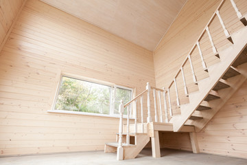 Empty wooden house interior with stairway