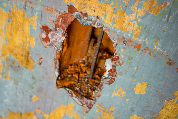 A hole in the wall of an old house, made by treasure hunters