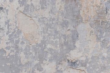 Old white concrete wall with cracks and chipped texture
