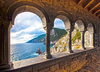 magical sea view through the castle and gothic Church of St. Peter arches in Porto Venere, Liguria, Italy