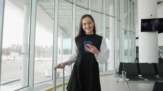 Portrait of a traveling business woman talking on cell phone at airport, happy student with suitcase run on flight happy smiling concept