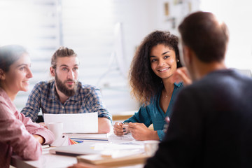 At office. A young man leads a multiethnic working group