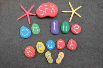 Sex on the beach, cocktail name with multicolored stones over black volcanic sand