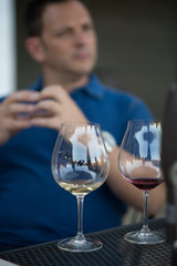 wine glasses in front of man