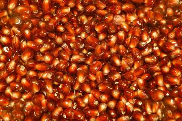 Ripe apple on pomegranate seeds.