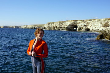 a girl on a feces by the sea