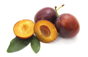 Blue plums with leaves.