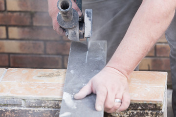 tiler cutting a tile with a grinder