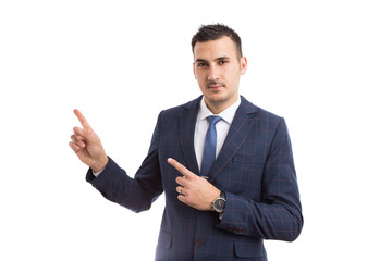 Young handsome businessman pointing with index fingers.