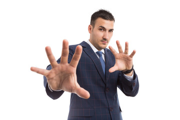 Young businessman or sales man with defensive gesturing.