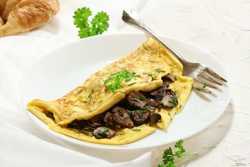 Homemade fluffy Mushroom Omelette garnished with Chives , selective focus