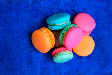 colored round cookies with cream on a blue background