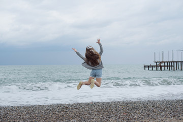 girl jumping near the sea